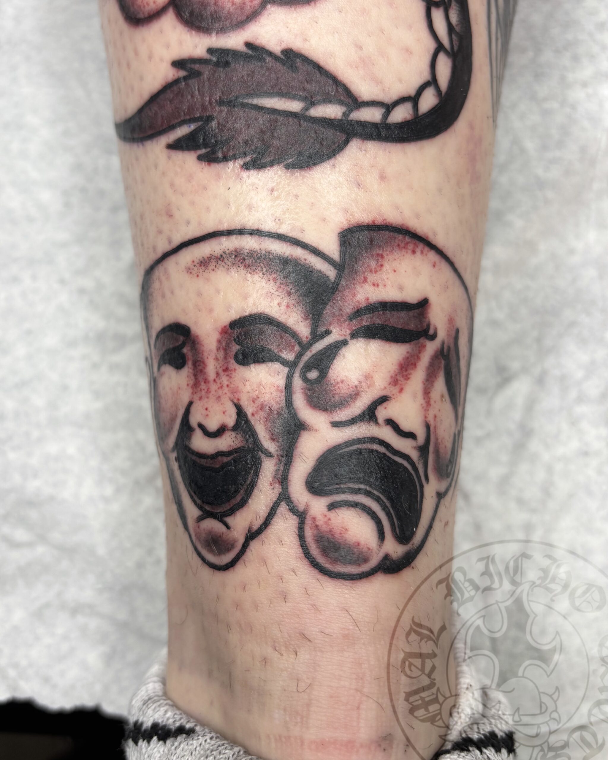 Tatuaje mascaras tradicional realizado en Granada. Reserva tu cita en Mal Bicho Tattoo.